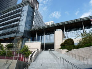 Photo of Seattle City Hall, a glass building viewed from the bottom of a long staircase.